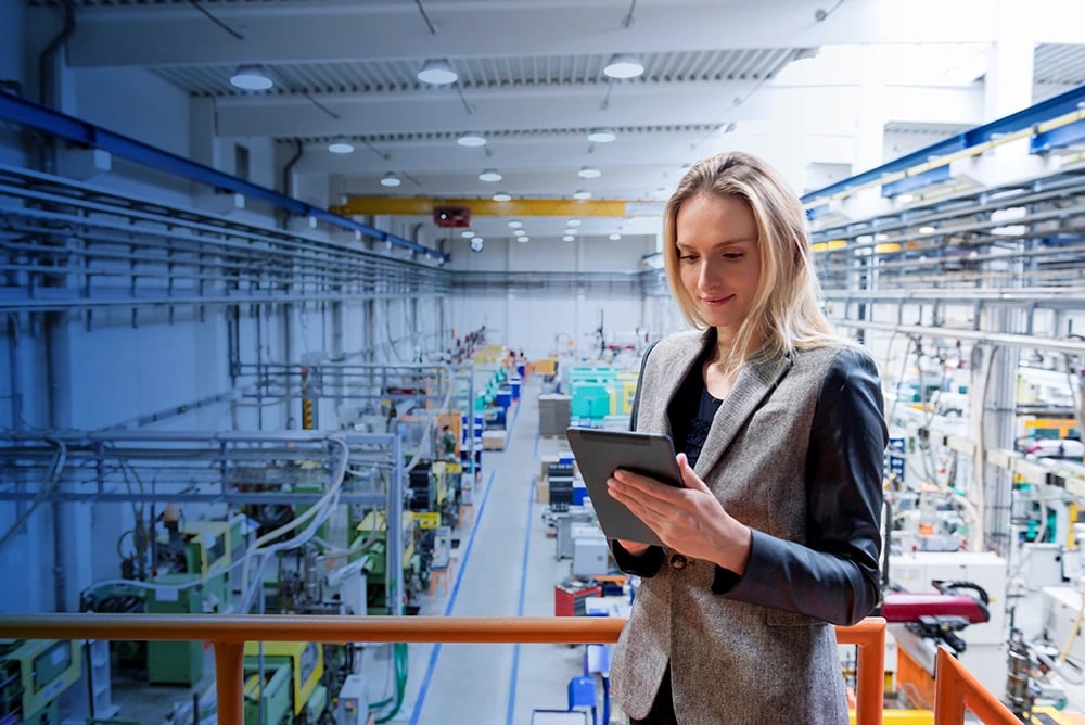 Business woman in warehouse with iPad